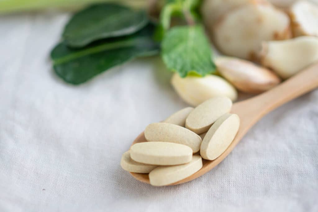 supplement tables on a wooden spoon