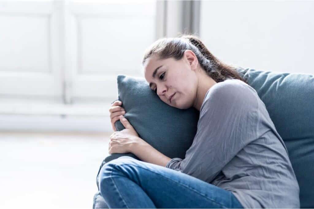 Image of woman laying her head on a pillow