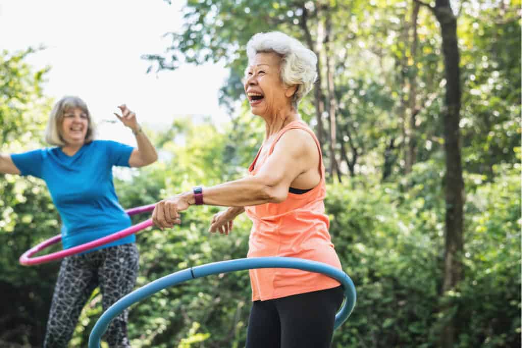 Two women hula hooping