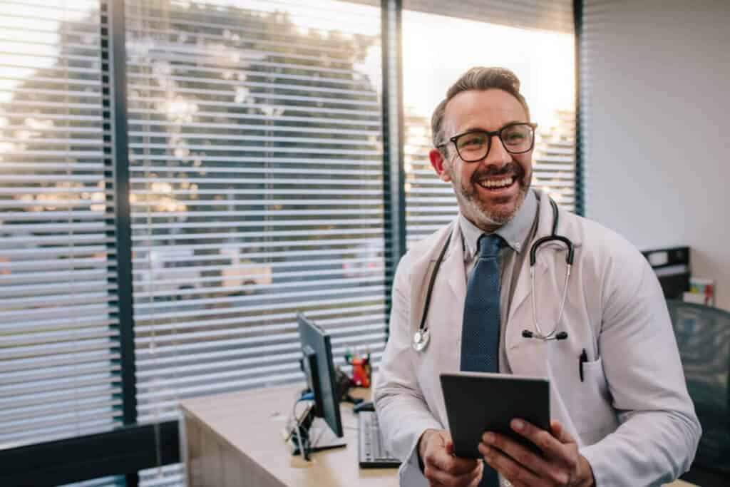 practitioner in his office smiling