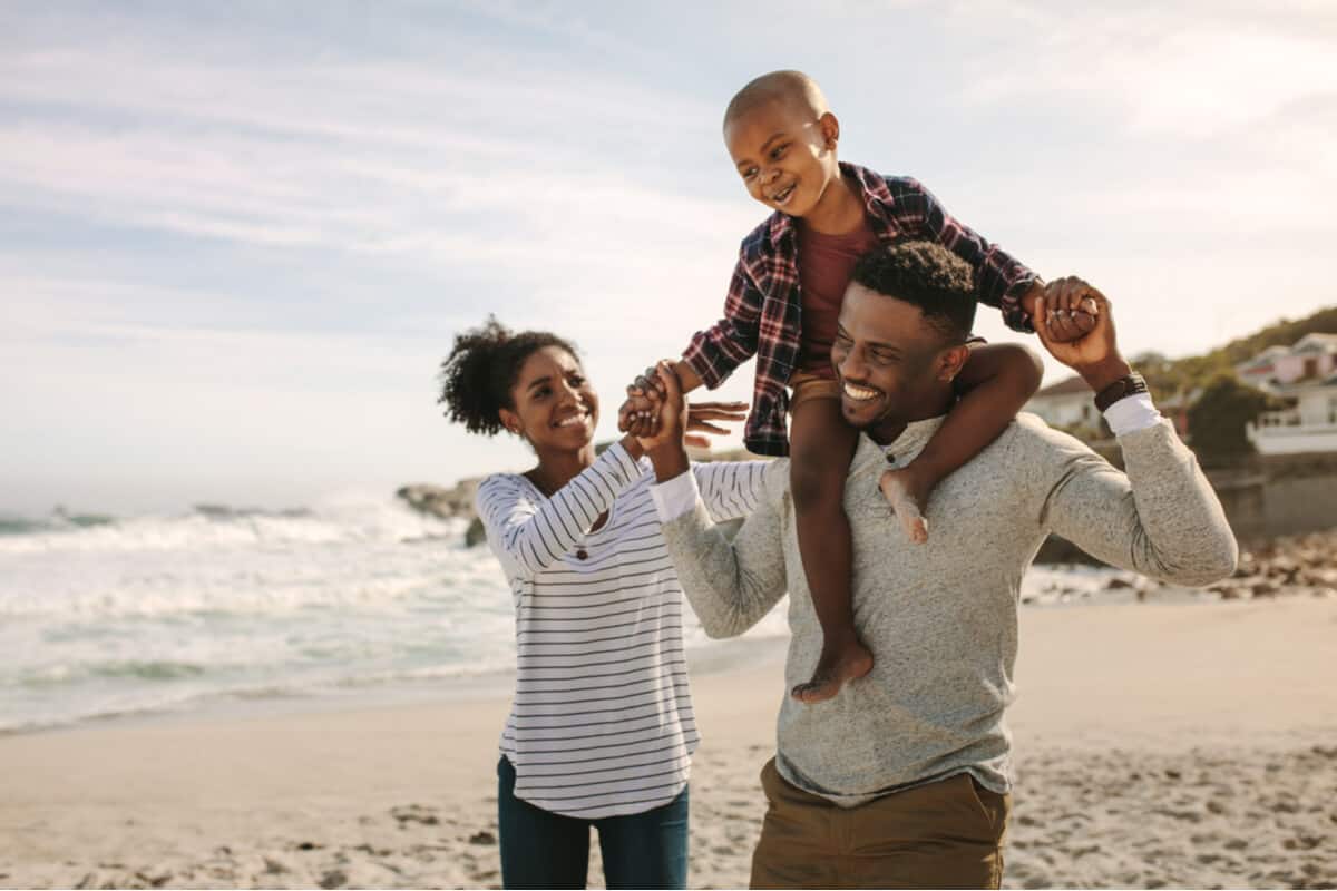 Man, woman and child walking on a beach