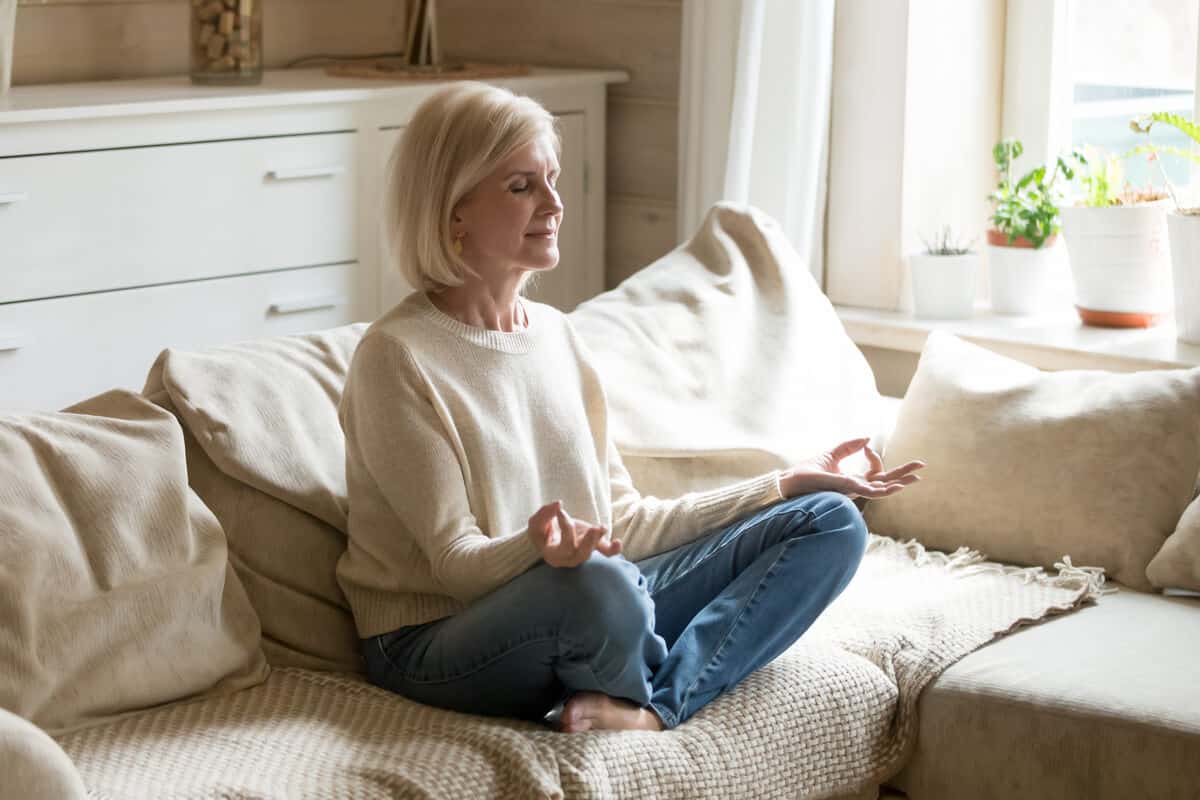 Woman meditating on a couch