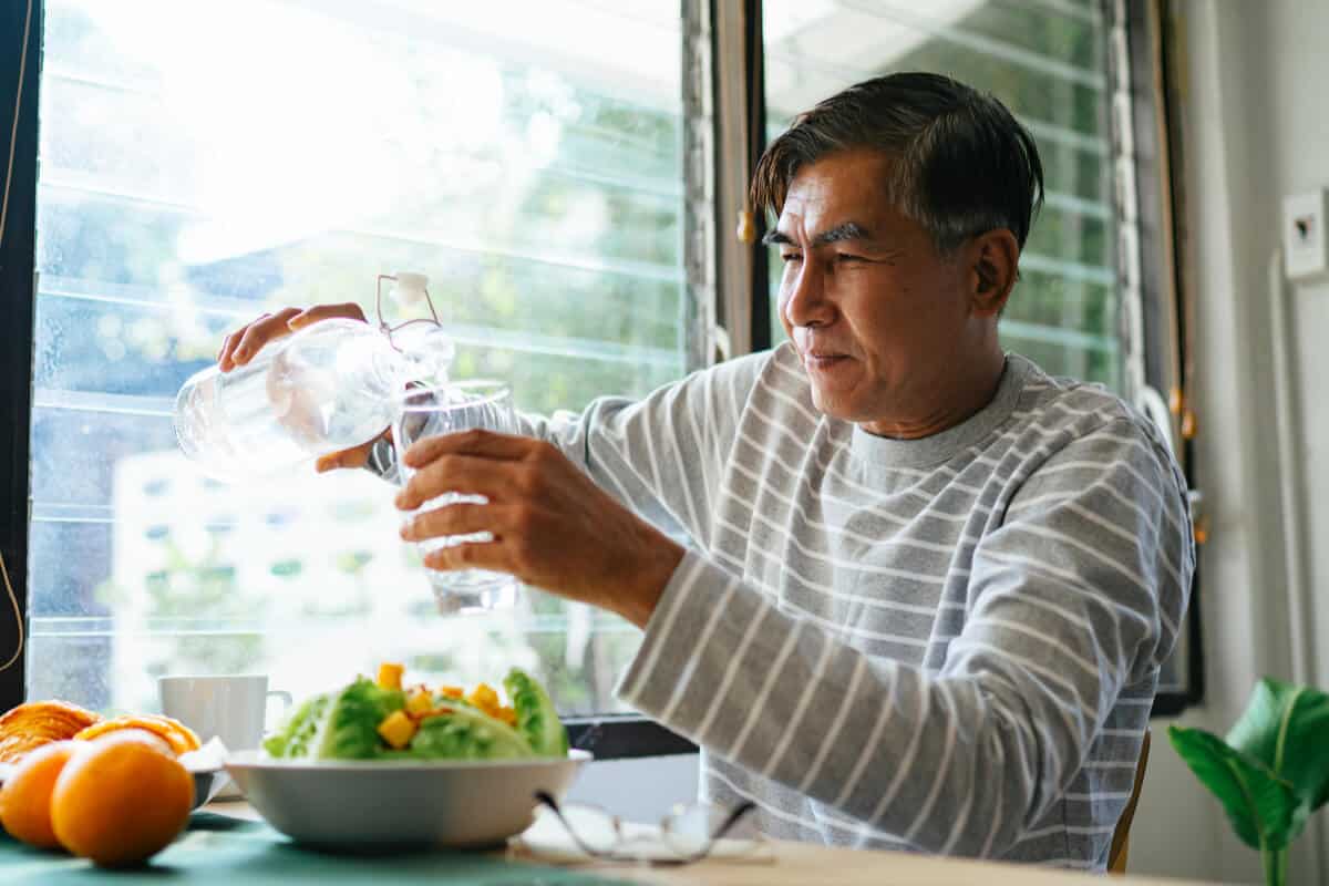 hydration man pouring water into a glass