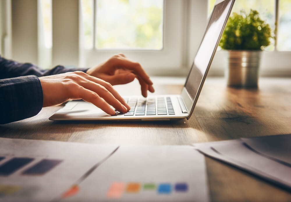 person typing on a laptop