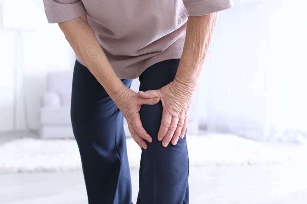 close up of person holding their left knee