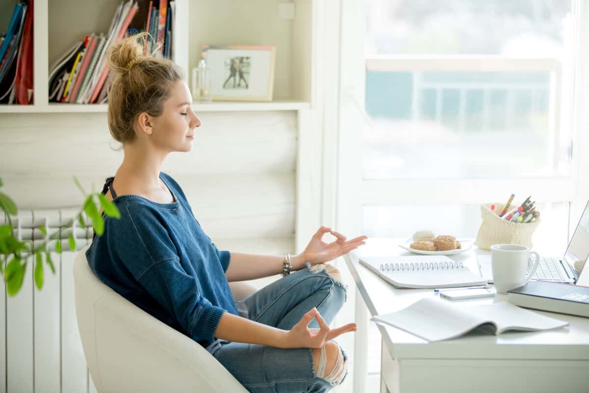 Woman meditating in a chair