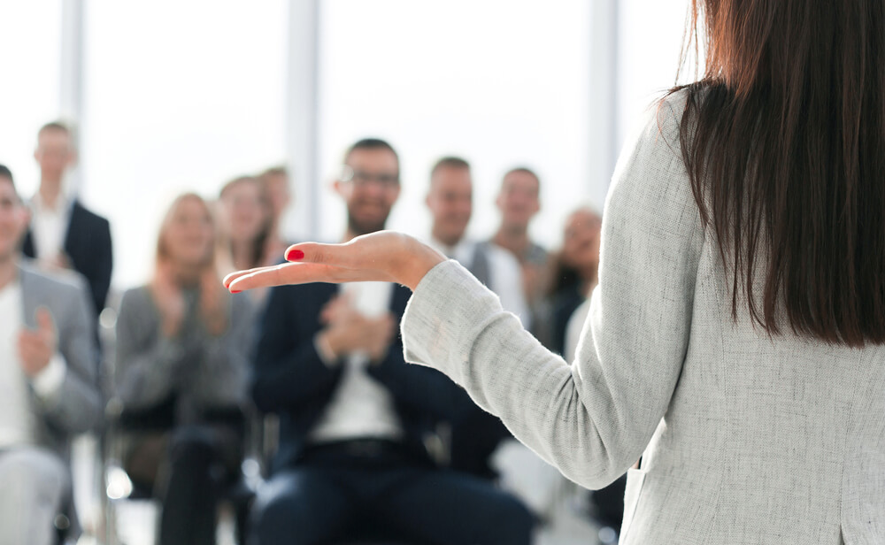 woman presenting to an audience