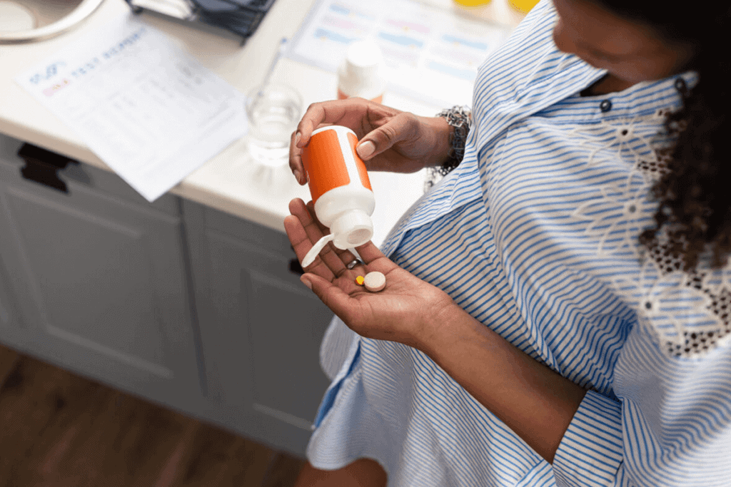 close up of woman holding a supplement bottle