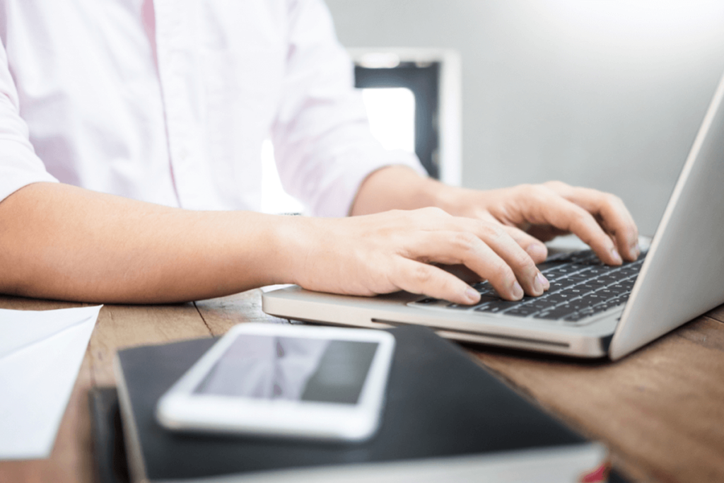 person typing on a laptop