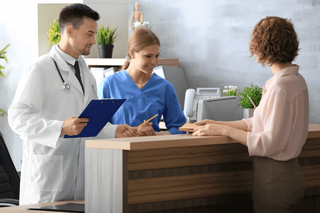 receptionist and doctor checking out a patient from the office