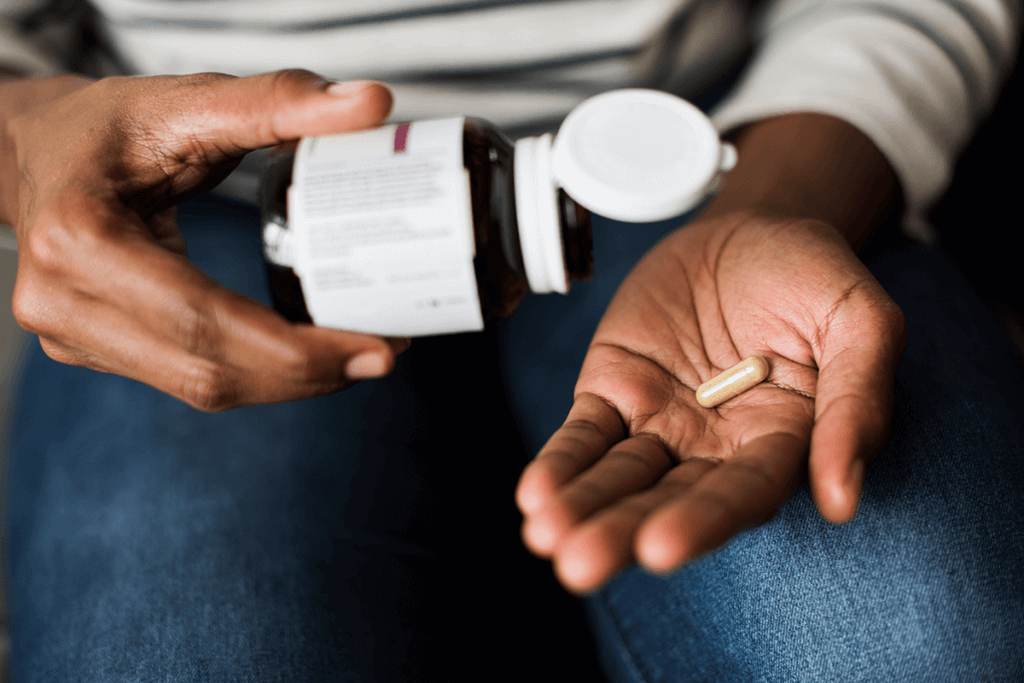 A supplement in a man's hand.