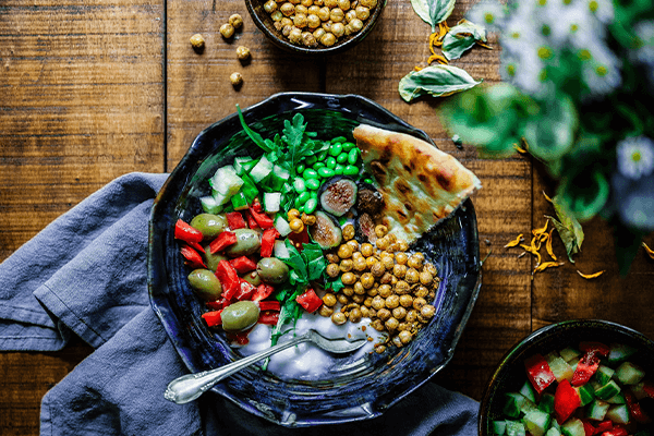 yogurt bowl with peas, chickpeas, naan bread